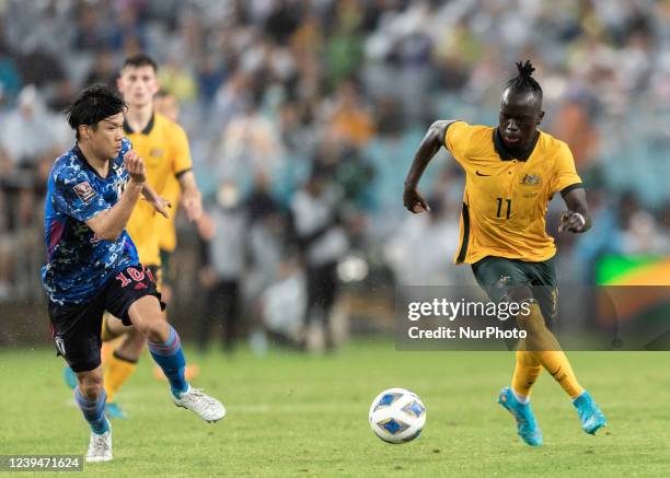 Awer Mabil of the Socceroos is challenged by Takumi Minamino during FIFA World Cup Qatar 2022 Qualification match between Australia and Japan at...