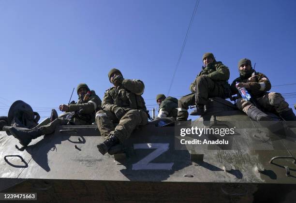 Russian military and pro-Russian separatists keep watch as civilians are being evacuated along humanitarian corridors from the Ukrainian city of...