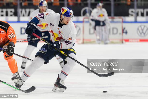 Philip Gogulla of EHC Red Bull Muenchen controls the ball during the Penny DEL match between Grizzlys Wolfsburg and EHC Red Bull München at Eis Arena...