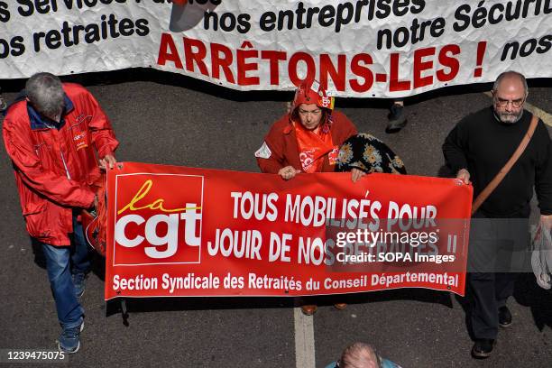 Protesters march with a banner expressing their opinion during the demonstration. Retirees have held protests in some 20 towns across France to...