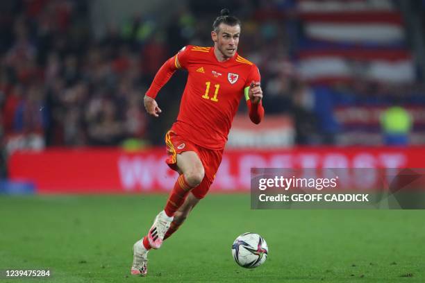 Wales' midfielder Gareth Bale runs with the ball during the FIFA World Cup 2022 play-off semi-final qualifier football match between Wales and...