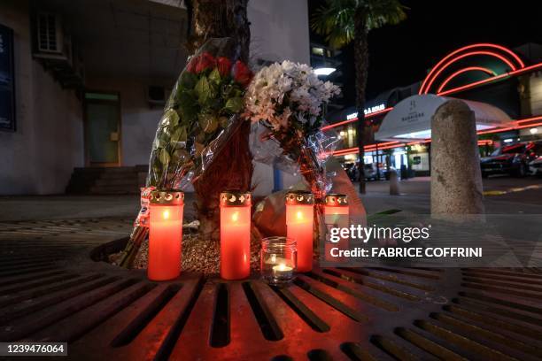 Flowers and candles are seen next to the building where five people who appeared to have jumped from their apartment in Montreux, western...