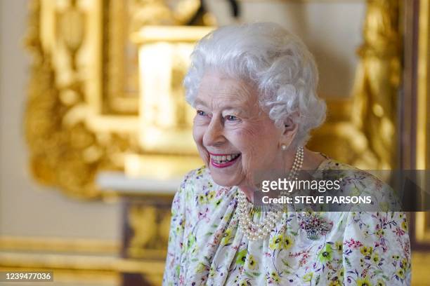Britain's Queen Elizabeth II smiles as she arrives to view a display of artefacts from Halcyon Days to commemorate the company's 70th anniversary in...