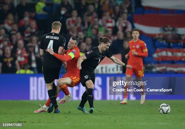 Wales' Gareth Bale is fouled by Austria's Martin Hinteregger and Aleksandar Dragovic during the 2022 FIFA World Cup Qualifier knockout round play-off...