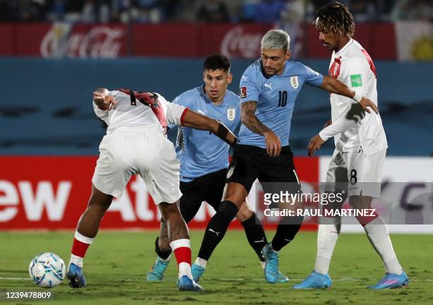 Peru's Renato Tapia and Uruguay's Giorgian De Arrascaeta vie for the ball during their South American qualification football match for the FIFA World...