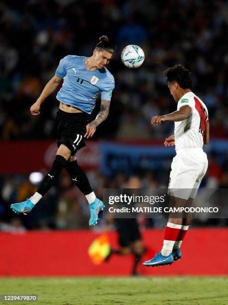 Uruguay's Darwin Nunez and Peru's Renato Tapia vie for the ball during their South American qualification football match for the FIFA World Cup Qatar...