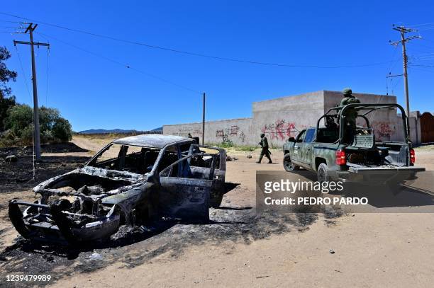 Burning truck is seen as Mexican soldiers arrive in the village of Palmas Altas, which had been taken over by criminal gangs and its residents had to...