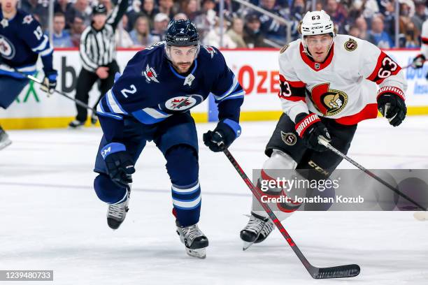 Dylan DeMelo of the Winnipeg Jets and Tyler Ennis of the Ottawa Senators follow the play down the ice during first period action at the Canada Life...