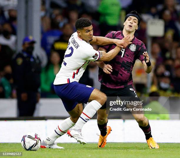 United States defender Antonee Robinson recieves a yellow card defending Mexico forward Raul Jimenez in the first half at Estadio Azteca on Thursday,...