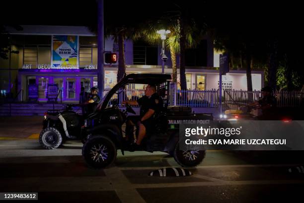 Miami Beach Police patrol Ocean Drive as a curfew goes into effect during Spring Break in Miami Beach, Florida, early on March 25, 2022. The US city...