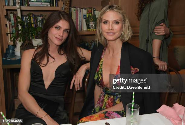 Elisa Sednaoui and Heidi Klum attend the LA launch dinner for the Green Carpet Fashion Awards at San Vicente Bungalows on March 24, 2022 in West...
