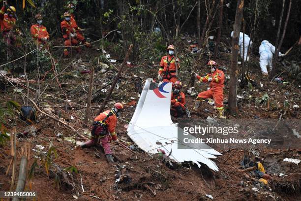 Rescuers conduct search and rescue work at a plane crash site in Tengxian County, south China's Guangxi Zhuang Autonomous Region, March 24, 2022....