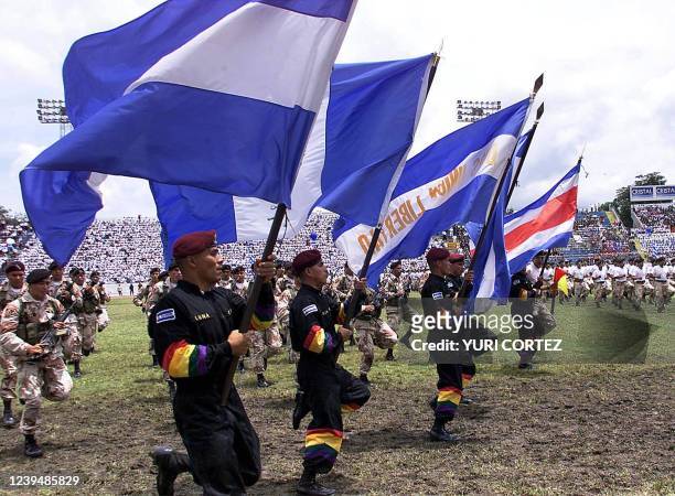 Paratroopers of the Salvadoran Air Force carry the five flags of Central American countries 15 September, 2000 during a military parade to...