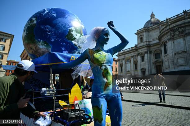 Dressed up climate activist from the 'Fridays for Future' movement takes part in a protest march against global profit on March 25, 2022 in Rome.