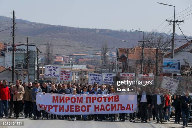 Kosovo Serbs hold a banner reading " Peace against Kurti's violations" in the town of Gracanica on March 25, 2022 as they part in a demonstration...