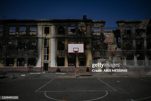 Picture shows a basketball net in front of a destroyed school in Kharkiv on March 25 during Russia's military invasion launched on Ukraine. - Russian...