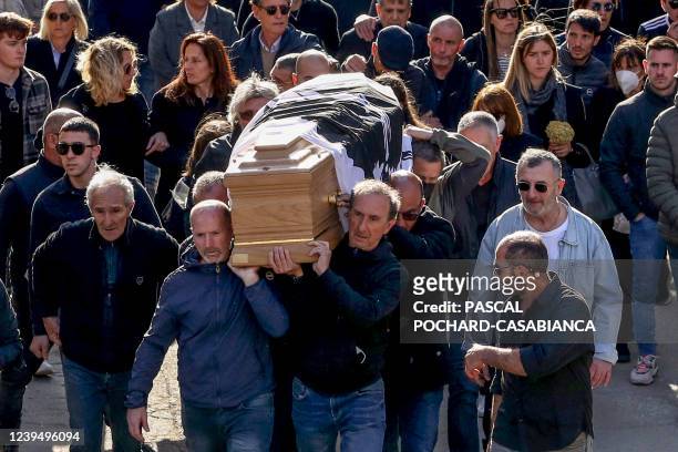 People follow the coffin of Corsican separatist and convicted killer Yvan Colonna after his funeral ceremony on March 25, 2022 in the Corsican...