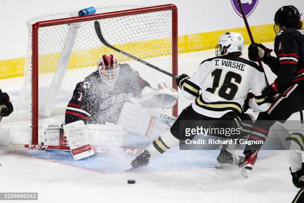 Devon Levi of the Northeastern Huskies makes a save against Tim Washe of the Western Michigan Broncos during the first period during the NCAA Men's...