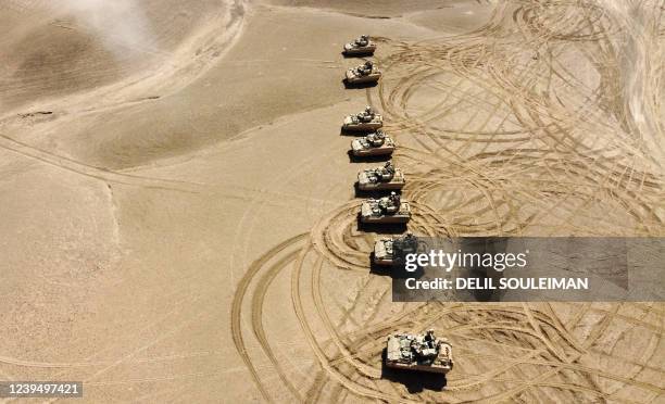 This aerial view shows troops from the Syrian Democratic Forces Special Operations and the US-led anti-jihadist coalition, take part in...