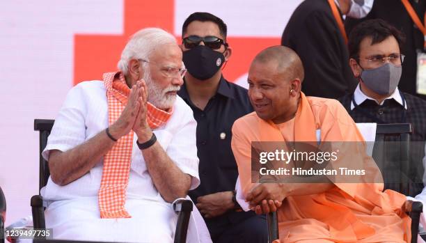 Prime Minister Narendra Modi interacts with Chief Minister of Uttar Pradesh Yogi Adityanath during a swearing in ceremony at Atal Vihari Vajpayee...