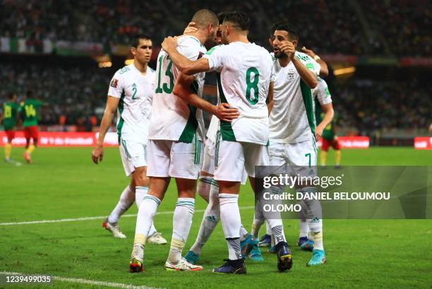 Algeria's Islam Slimani celebrates a goal with teammates during the FIFA World Cup Qatar 2022 qualifying third round football match between Algeria...