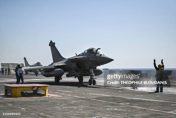 Rafale fighter jet lands on the Charles-de-Gaulle aircraft carrier, on March 25, 2022 during military exercises on board the French aircraft carrier...