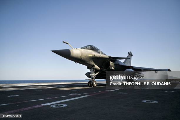 Rafale fighter jet prepares to take off from the Charles-de-Gaulle aircraft carrier, on March 25, 2022 during military exercises on board the French...