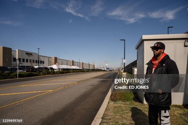 Amazon union leader Christian Smalls waits as workers make cast their vote over whether or not to unionize, outside an Amazon warehouse in Staten...