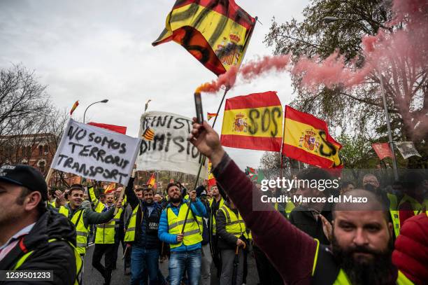 Truck drivers wearing yellow vests carrying placards and lighting smoke flares are seen protesting near the Ministry of Transport during the 12th day...