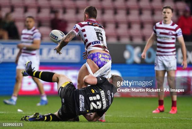 Wigan Warriors Cade Cust loses his shorts in a tackle from Salford Red Devils James Greenwood during the Betfred Challenge Cup match at the DW...