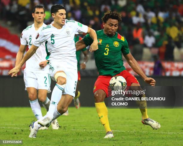 Algeria's Mehdi Tahrat vies for the ball with Cameroon's Léandre Tawamba during the FIFA World Cup Qatar 2022 qualifying third round football match...