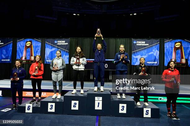 The 8 epee finalists stand on the podium after the Division I Womens Fencing Championship held at the Castellan Family Fencing Center on March 25,...