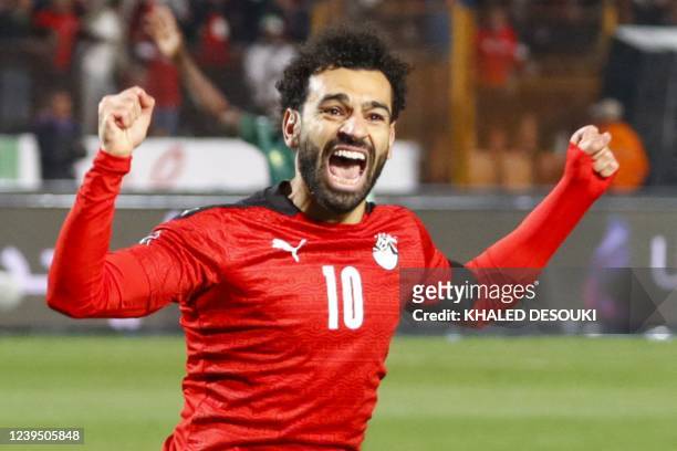 Egypt's forward Mohamed Salah celebrates after a goal during the 2022 Qatar World Cup African Qualifiers football match between Egypt and Senegal at...