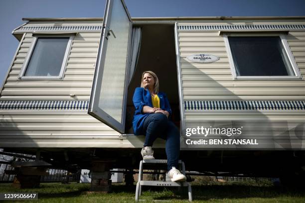 Tanya Chenery poses in front of a static caravan which she has offered to house Ukranian refugees in Diss, eastern England, on March 22, 2022. - A...