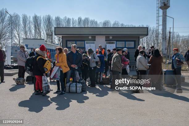People wait at the border for transport to take them to the Palanca refugee camp. Palanca is a small town on the border with Ukraine and is the...
