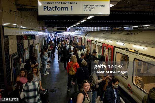 View of a busy London underground station during peak hours.