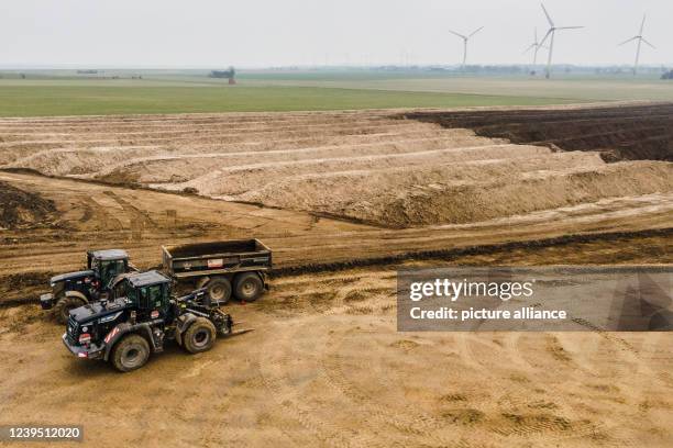 March 2022, Schleswig-Holstein, Fehmarn: Construction vehicles stand on the building site during the construction of the Baltic Sea Tunnel . Soil...