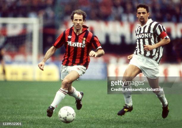 Franco Baresi of AC Milan competes for the ball with Roberto Baggio of Juventus during the Serie A match between AC Milan and Juventus at stadio...