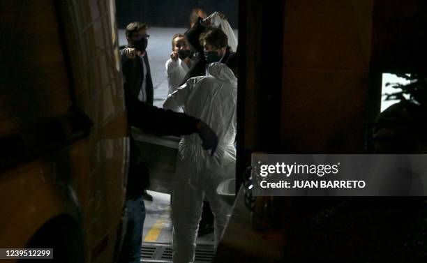 Member's of the Technical Investigation Team transport Foo Fighters' drummer Taylor Hawkins body from a hotel in Bogota on March 26, 2022. - Drummer...