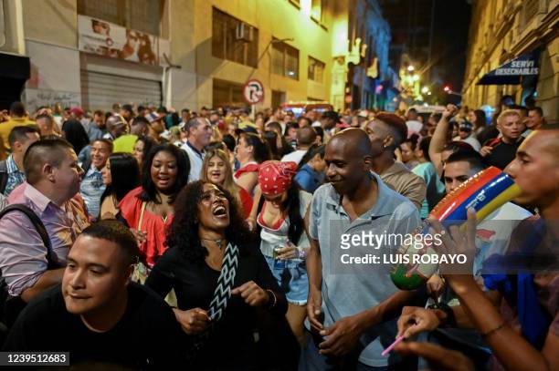 People dance salsa in a street known as "the street of sin" in downtown in Cali, Colombia on March 25, 2022. - In Cali, appeal as the World Capital...