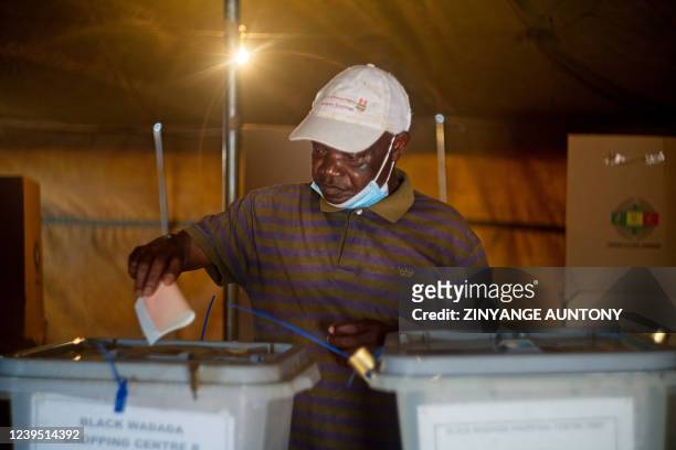 Man cast a ballot during a by-election at a polling station on March 26, 2022 in Mbizo township, Kwekwe. - Zimbabweans cast ballots on Saturday in...