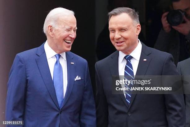 President Joe Biden and Polish President Andrzej Duda shake react during an official wecoming ceremony prior to a meeting in Warsaw on March 26, 2022.