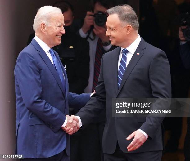 President Joe Biden and Polish President Andrzej Duda shake hands during an official wecoming ceremony prior to a meeting in Warsaw on March 26, 2022.