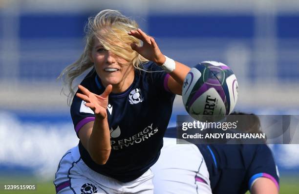 Scotland's scrum-half Jenny Maxwell passes the ball during the Six Nations international women's rugby union match between Scotland and England at...