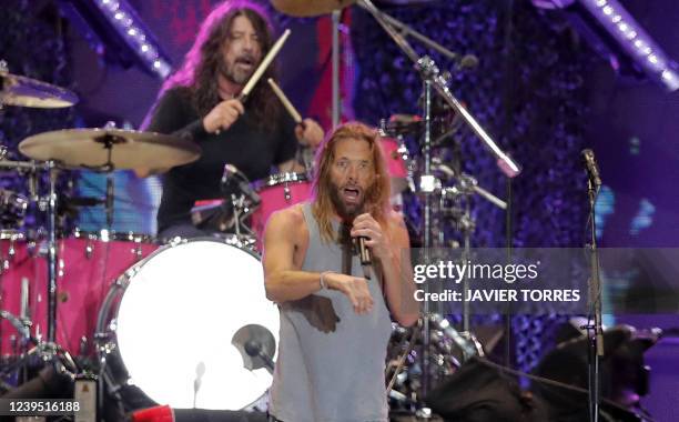 Picture taken on March 18, 2022 of Foo Fighters' drummer Taylor Hawkins and lead singer Dave Grohl on stage, at the Lollapalooza 2022 music festival...