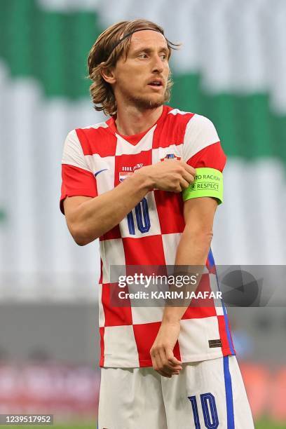 Croatia's midfielder Luka Modric adjusts his captain armband during the friendly football match between Croatia and Slovenia at Education City...