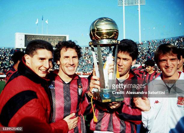 Daniele Massaro, Franco Baresi, Carlo Ancelotti and Stefano Carobbi celebrate the victory with the trophy after winnig the 1998 Intercontinental Cup...