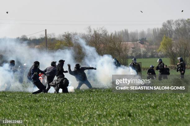 Protesters throw stones at gendarmes during a demonstration part of a three-day gathering dubbed "Printemps maraichin", called by the collective...