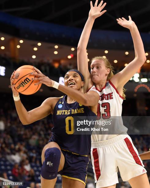 Maya Dodson of the Notre Dame Fighting Irish drives by Elissa Cunane of the North Carolina State Wolfpack during the Sweet 16 round of the 2022 NCAA...