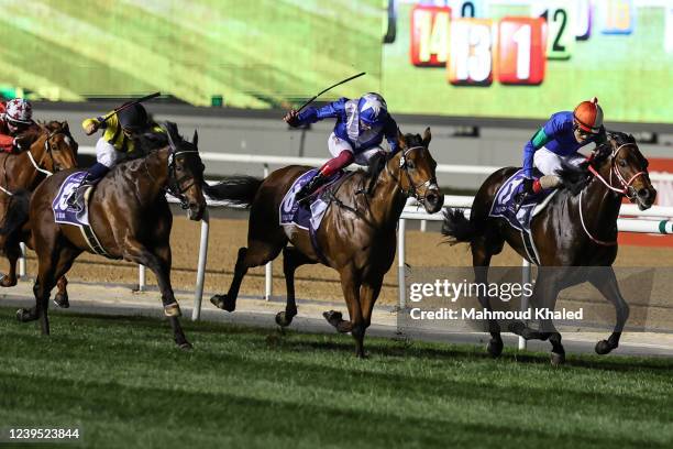 Lanfraco Dettori jockey of Lord North and Yutaka Yoshida jockey of anthalassa wins the Dubai Turf at the Meydan Racecourse on March 26, 2022 in...